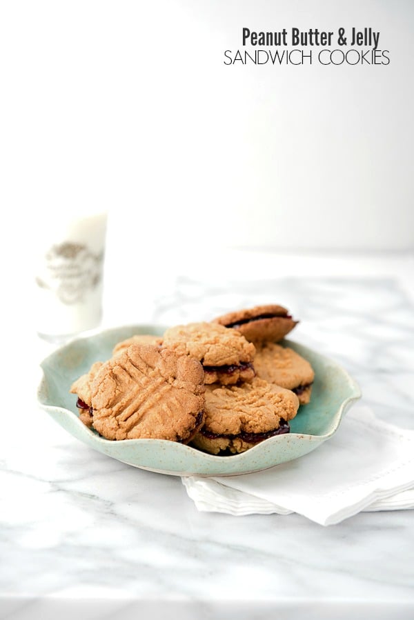 Peanut Butter and Jelly Sandwich Cookies with a glass of milk -