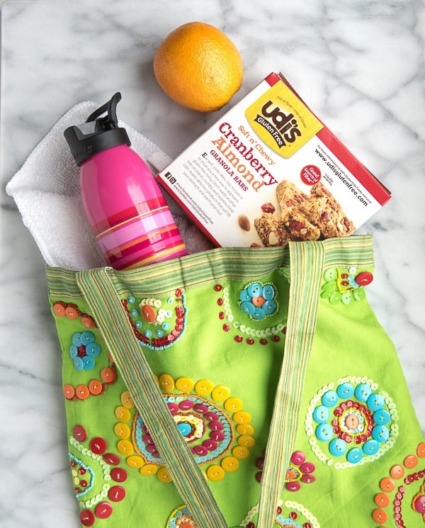 gluten-free post workout snacks, granola bars, an orange and water in a colorful bag