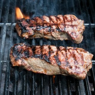 grilling New York Strip Steak with flame