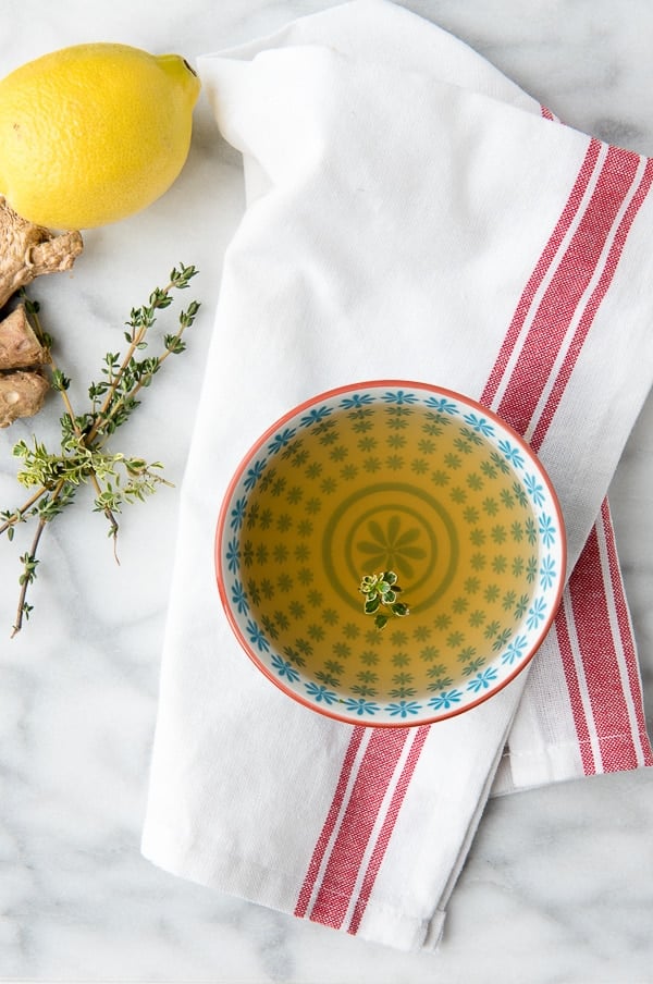 Slow Cooker Lemon and Ginger Sipping Broth with lemon thyme leaves, ginger, lemon and thyme