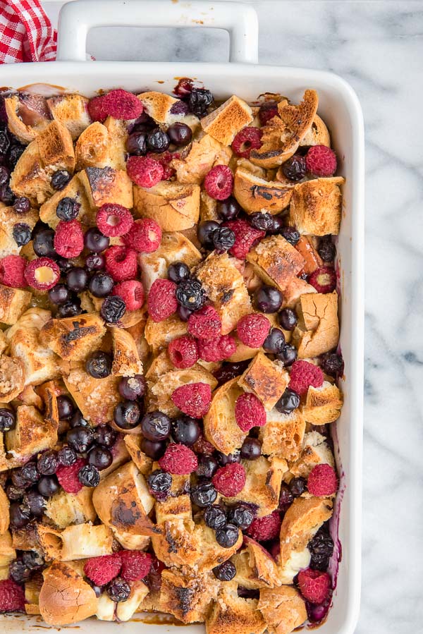 Baking dish of gluten-free Overnight French Toast Casserole with blueberries, raspberries and blackberries 