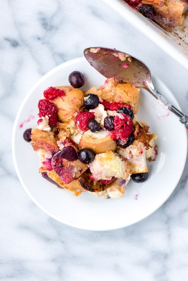 Single serving of Overnight French Toast Casserole on a white plate with spoon