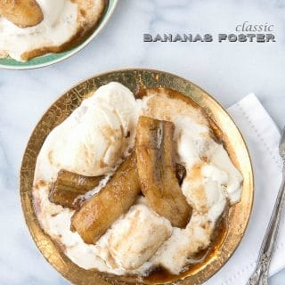 Classic Bananas Foster recipe. Boozy caramelized flambeed bananas served hot over scoops of cold vanilla ice cream!
