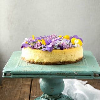 Creamy Lemon Cheesecake with Vanilla Wafer Crust and Edible Flowers