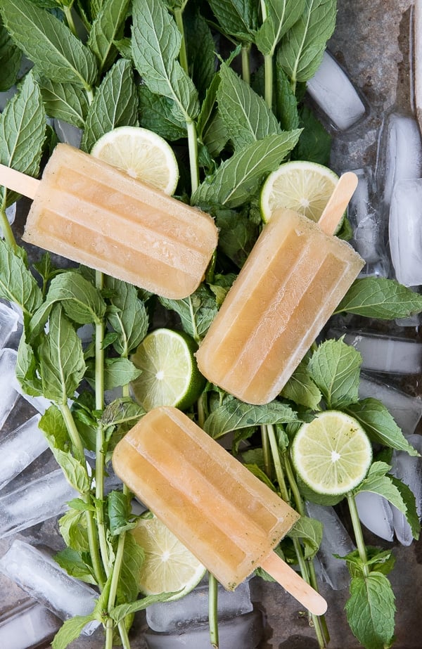 Guava-Lime Mojito Popsicles on bed of mint leaves
