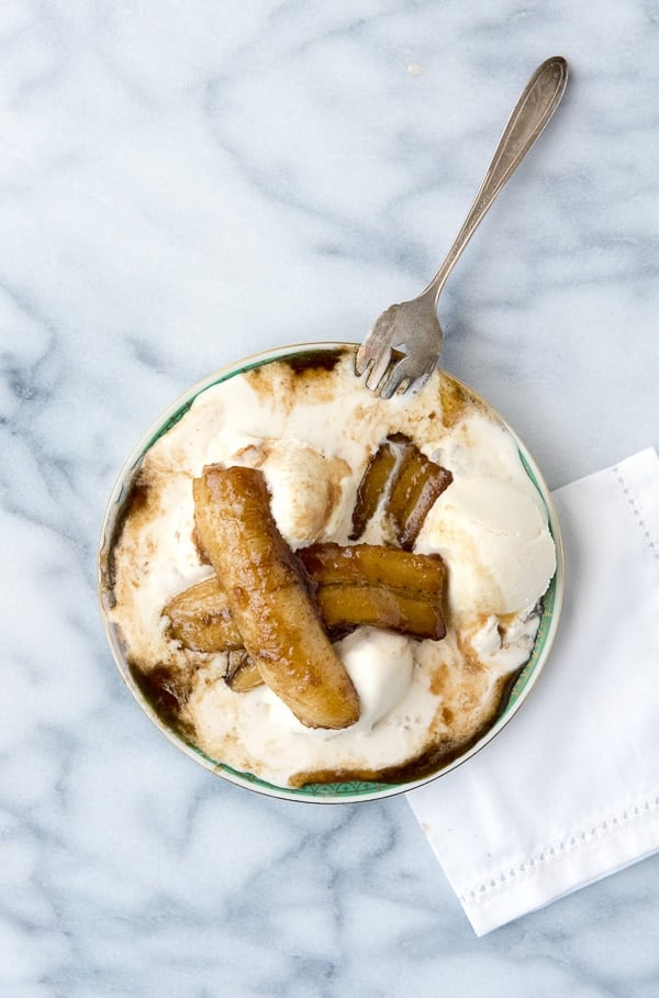 Traditional Bananas Foster. Bananas flambeed in rum and a buttery caramel sauce atop cold scoops of vanilla ice cream 