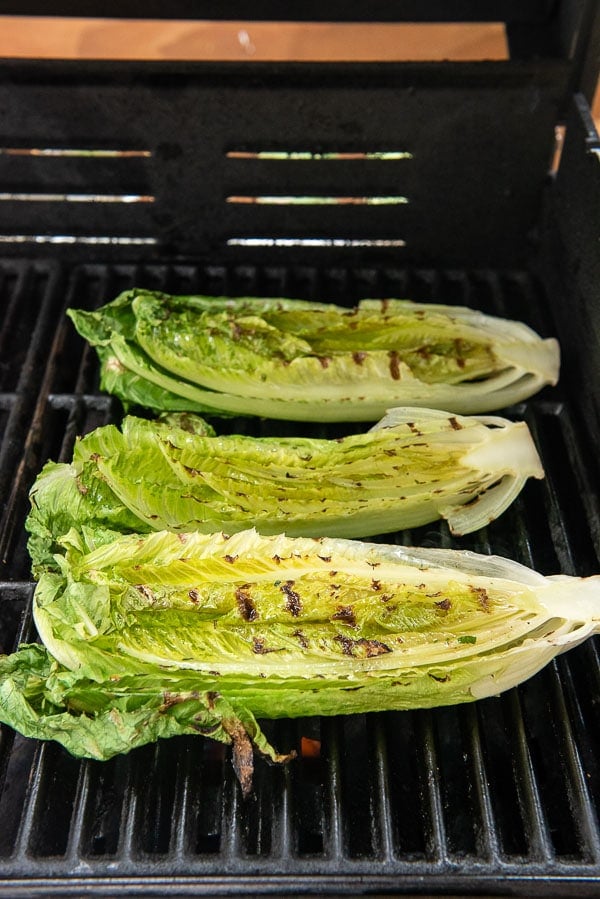 Grilled romaine lettuce hearts on a grill