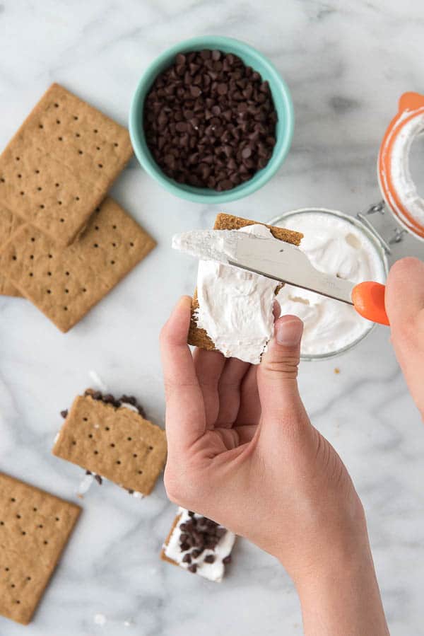 spreading homemade marshmallow fluff on gluten-free graham crackers