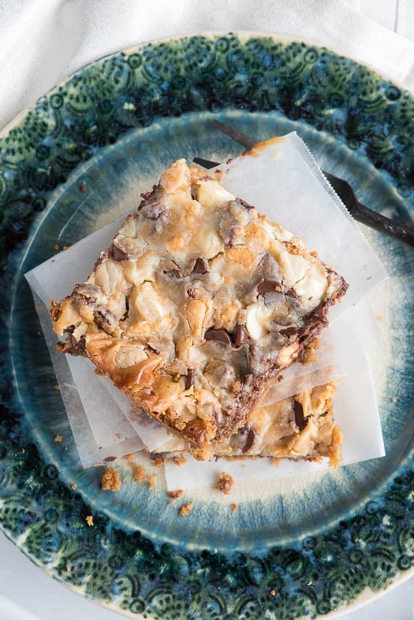 Mermaid Bait Bars with semi sweet chocolate, white chocolate and butterscotch on a graham cracker crust stacked on a green plate