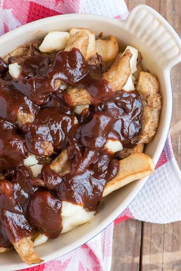 Barbecue Beef Poutine with Beer-Battered Onions  close up with bbq sauce