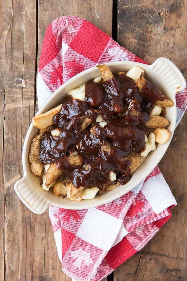 Barbecue Beef Poutine with Beer-Battered Onions with french fries, shredded bbq beef, cheese curds, fried onion strips, barbecue sauce