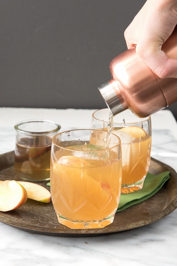 Spiced Apple Cider Whisky Sour cocktail pouring cocktail shaker