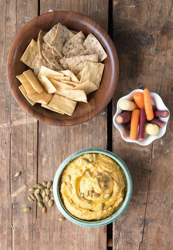 chipotle pumpkin hummus with crackers and colorful carrots