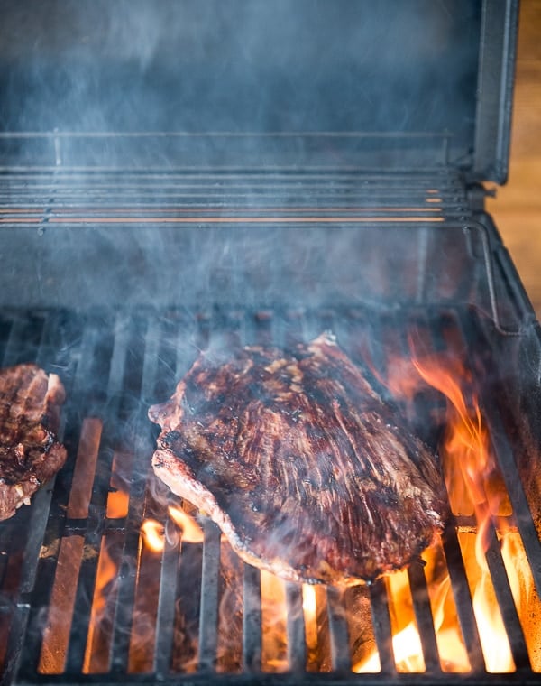 steak on grill with flames