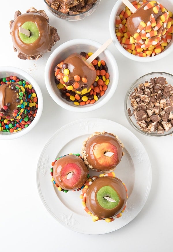 Caramel apples with bowls of candy to coat them