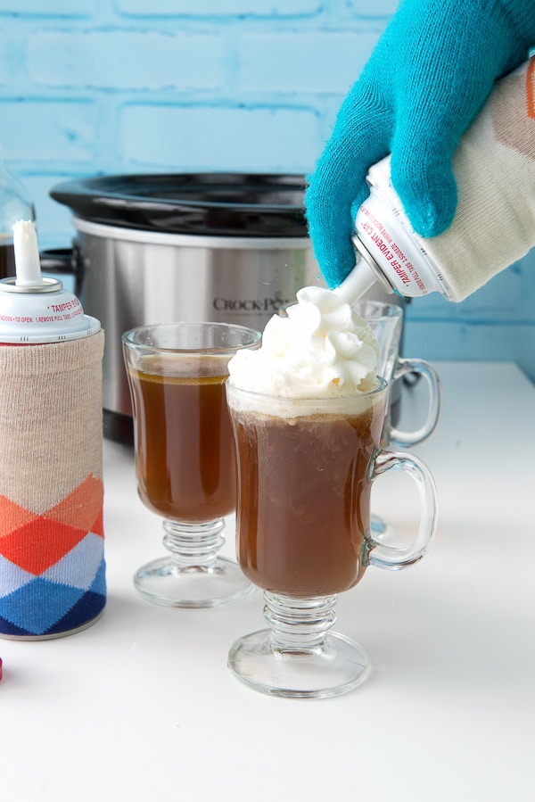 a glass mug of Hot Buttered Rum with whipped cream