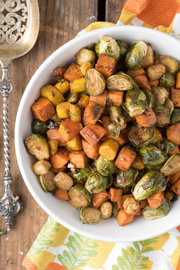 Herb Roasted Garlic Brussels Sprouts Sweet Potatoes and Carrots in bowl