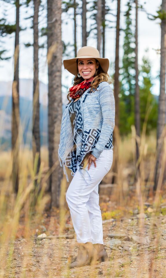 A person standing in front of a forest