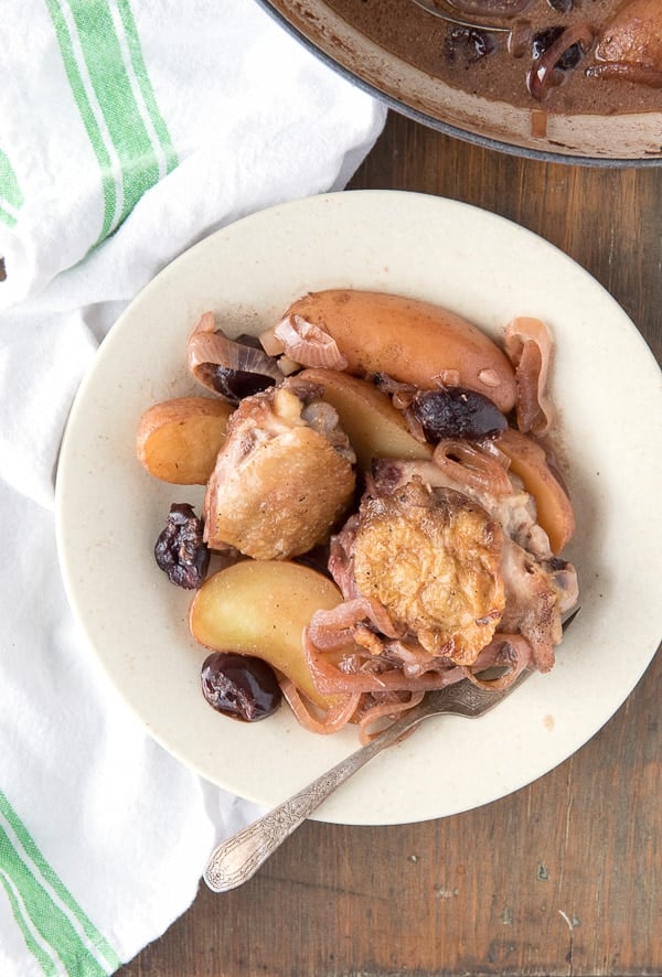Braised Cream Sherry Chicken Thighs with Cherries and Fingerling Potatoes in bowl