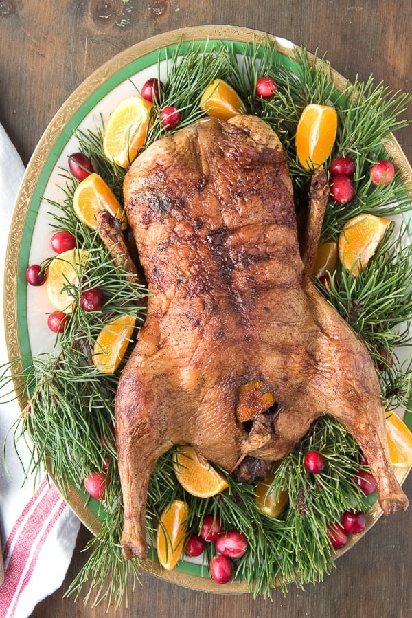 Easy Roast Whole Duck with Chinese Five Spice with greenery and orange wedges