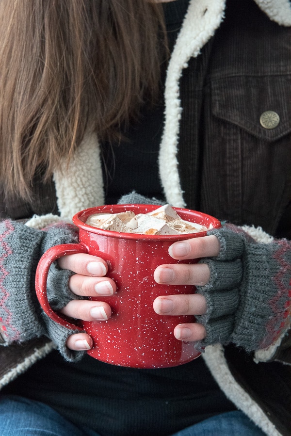 Homemade Vanilla-Coffee Liqueur Marshmallows in red enamel mug held by woman