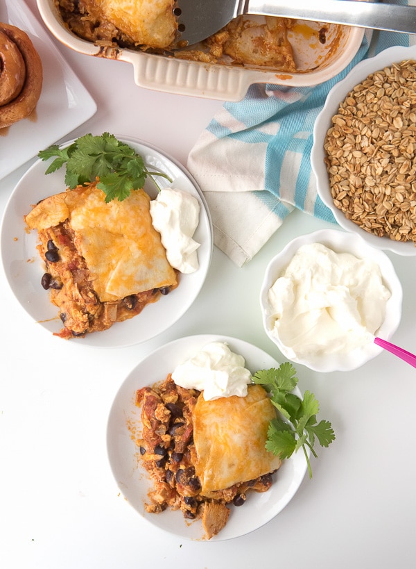 Mexican Breakfast Chicken Tortilla Lasagna Casserole on plates with sour cream