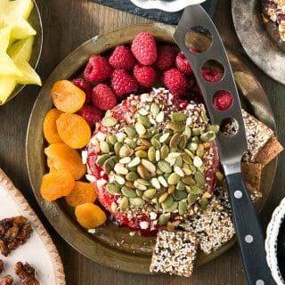 Spicy Cranberry-Raspberry Baked Brie with Toasted Hazelnuts and Pepitas