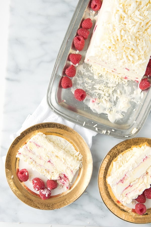 White Chocolate Raspberry Semifreddo slices on gold rimmed plates