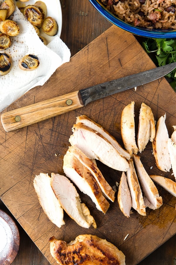slices of chicken breast on a wooden cutting board