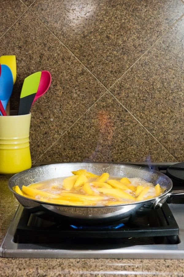 Flambeeing Mangos in a skillet for Mangoes Diablo