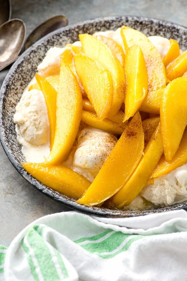 bowl of flambéed mangoes served over vanilla ice cream - Mangoes Diablo