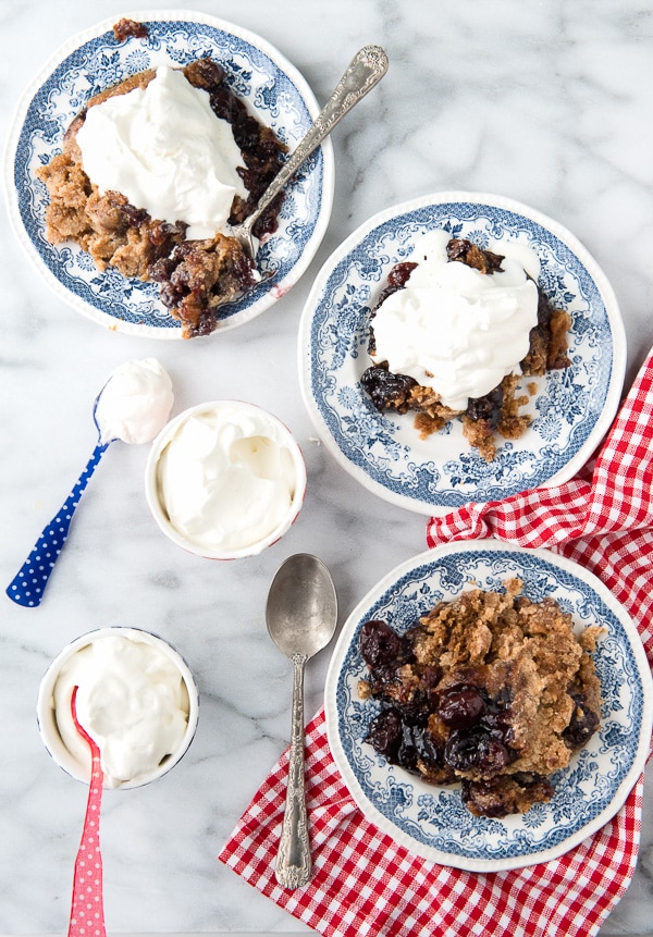 3 bowls of Slow Cooker Cherry Spice Cake Cobbler on a marble counter top