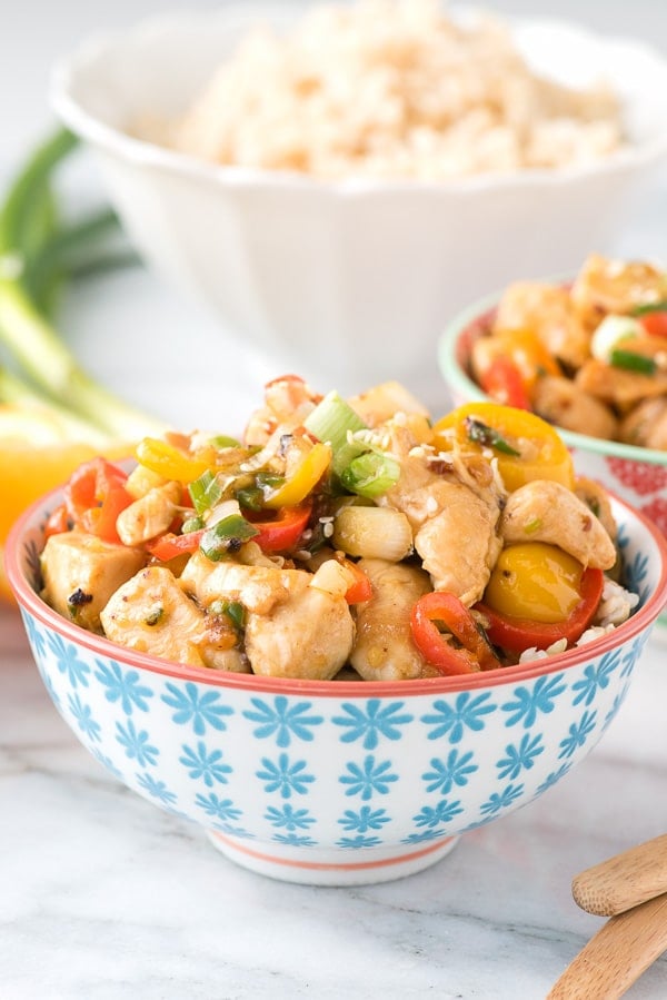 Spicy Ginger Chicken Stir Fry served in a white bowl with blue flowers painted on it