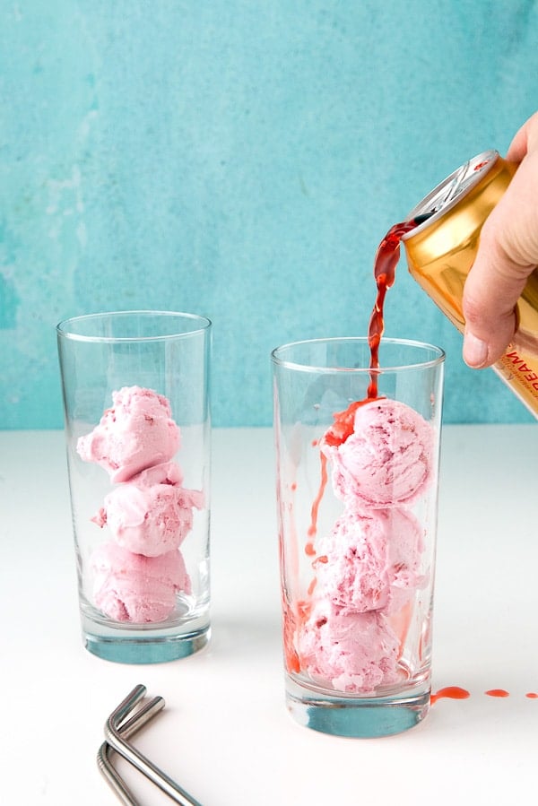 pouring strawberry soda into glasses of ice cream to make Strawberries and Cream Ice Cream Floats