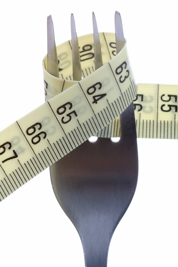 fork wrapped with tape measure