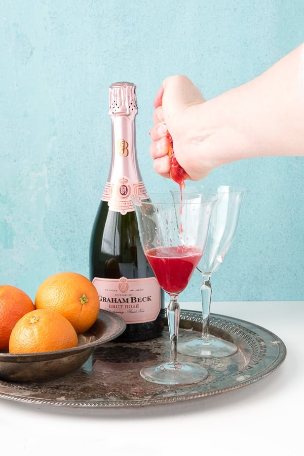 Blood Orange Mimosas (squeezing blood orange)