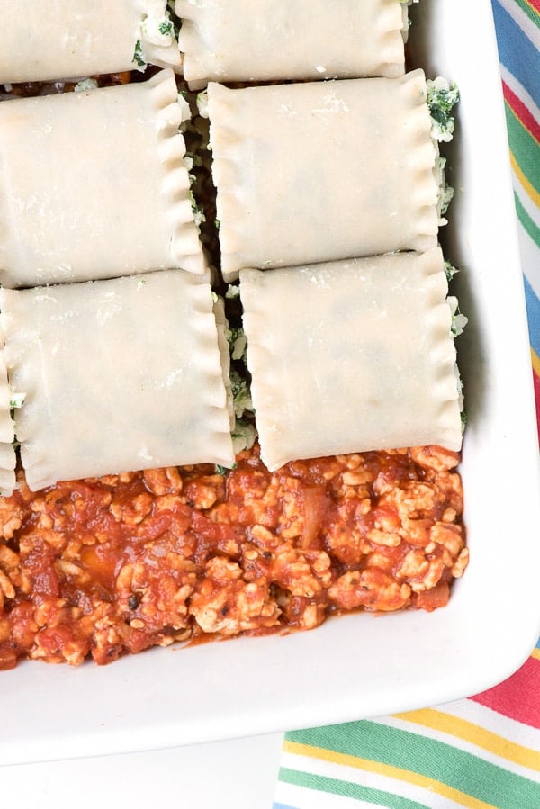 unbaked Gluten-Free Meat Lasagna Roll Ups in a white casserole dish