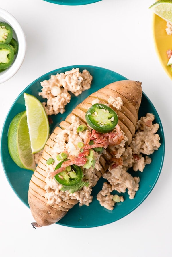 aqua dinner plate holds a Hasselback style Sweet Potato with Creamed Chipotle Turkey