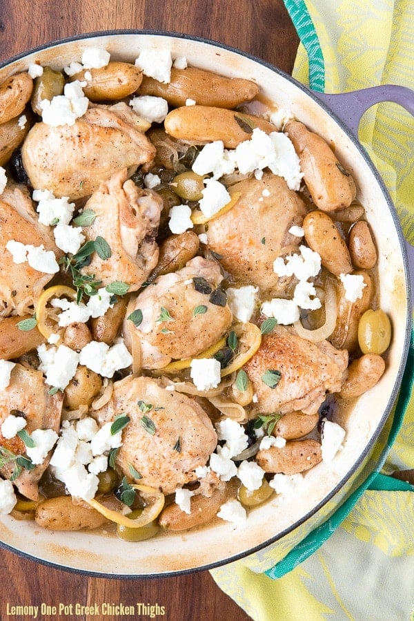 Lemony one pot Greek chicken thighs, shown sitting in the Dutch oven they were cooked in.