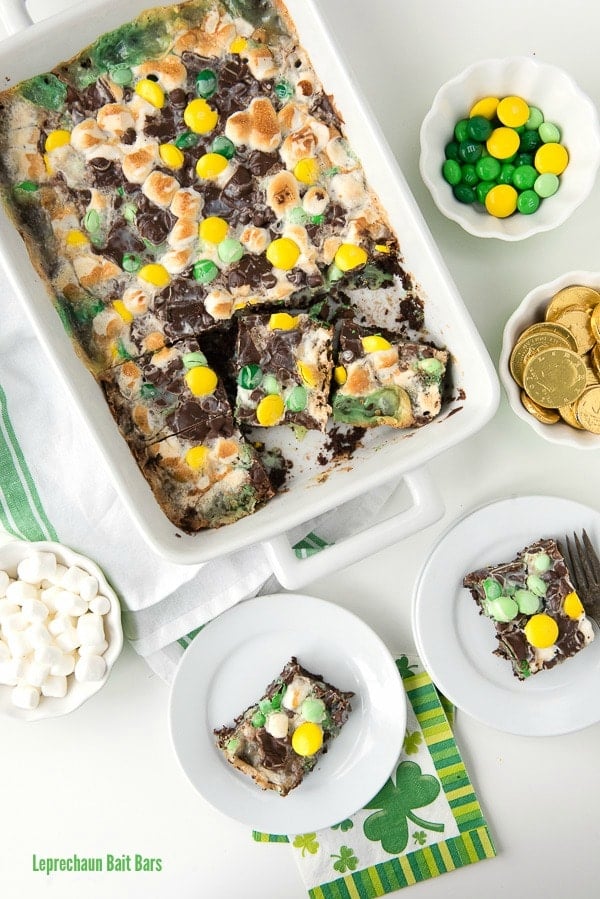 chocolate mint Leprechaun Bait Bars baked into a white baking dish, surrounded by some of the ingredients used to make them