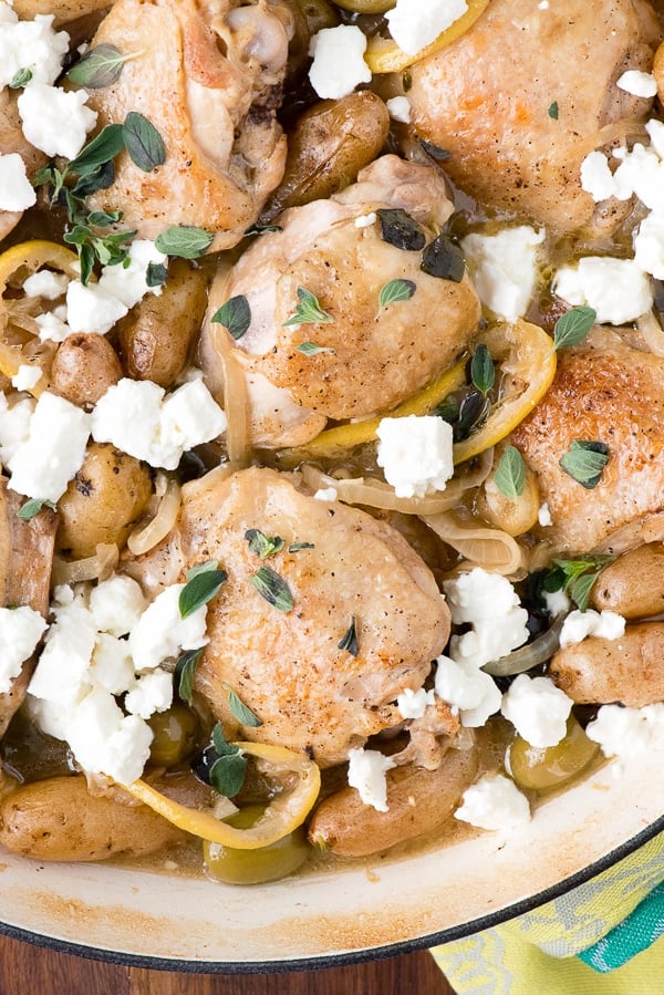 close up image of Lemony Greek Chicken Thighs topped with fresh feta cheese and green olives