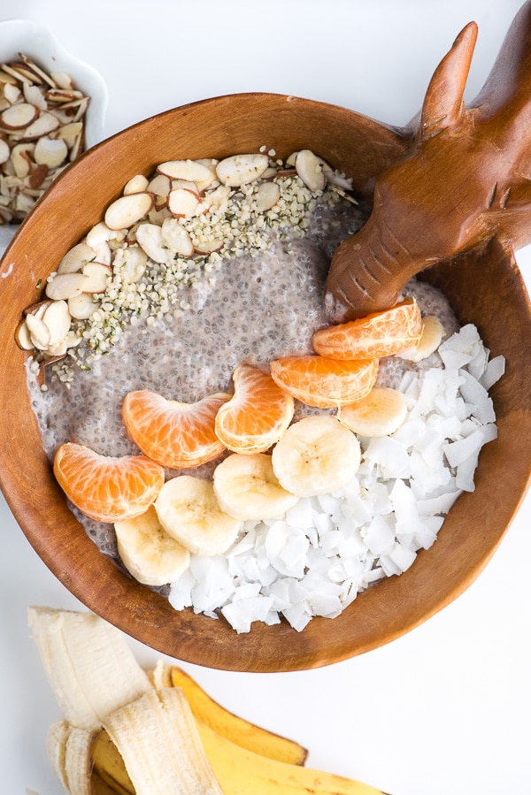 Wooden carved bowl with a Roasted Banana Chia Pudding Breakfast in it