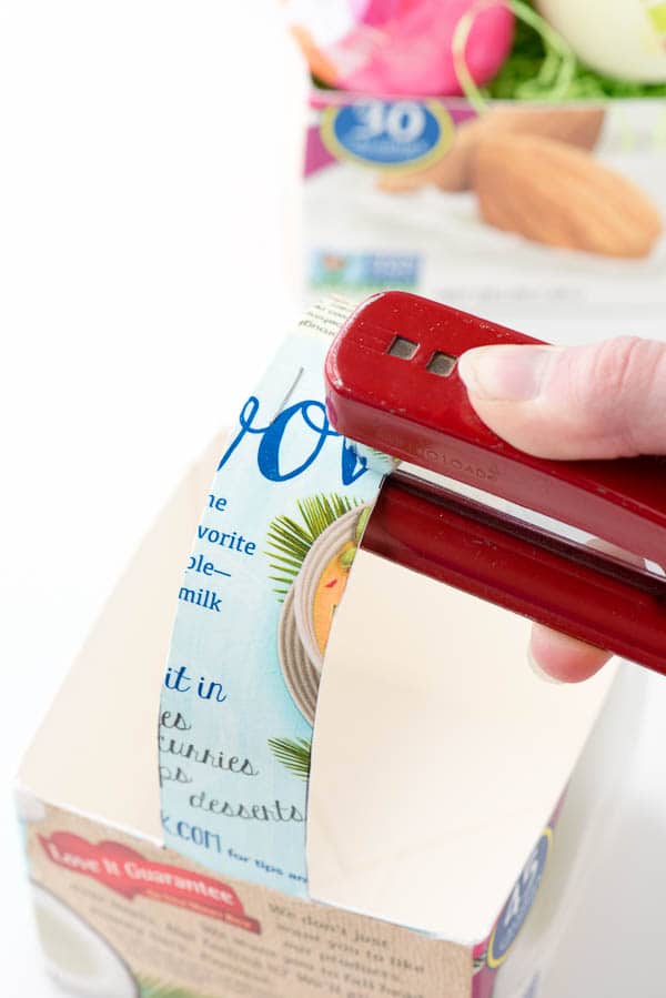 stapling a milk carton to make Milk Carton Baskets