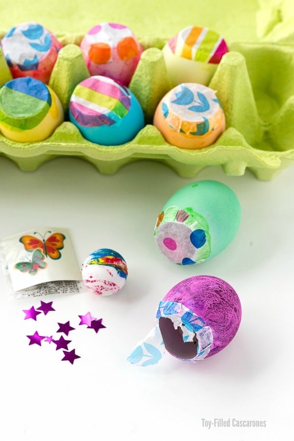 Toy-Filled Cascarones or Confetti Eggs in an egg carton with trinkets for filling eggs