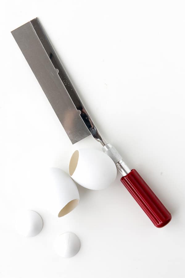 Xacto razor saw and artificial dyeable eggs with tops cut off