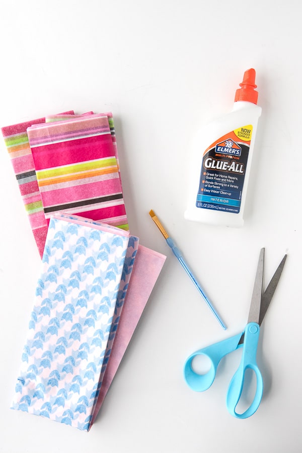 colorful tissue paper, paint brush, glue bottle and scissors for making cascarones confetti eggs