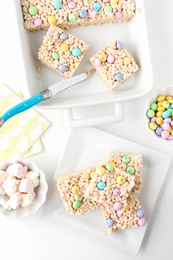 squares of Fruity Springtime Crispy Rice Cereal Marshmallow Treats on a white plate 