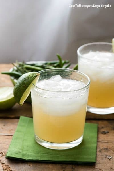 2 cocktail glasses of Thai Lemongrass Ginger Margaritas garnished with a fresh lime wedge