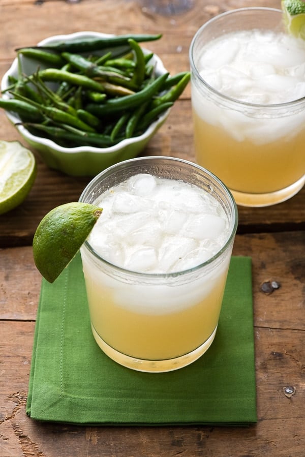 overhead photo of 2 Spicy Thai Lemongrass Ginger Margaritas and a bowl of Thai chiles