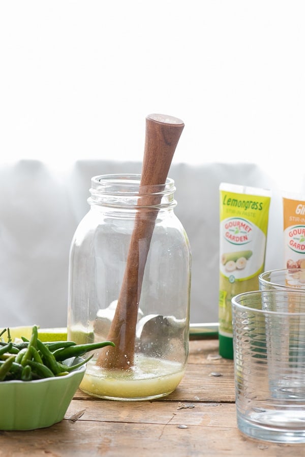 ingredients and tools to muddle a Spicy Thai Lemongrass Ginger Margarita